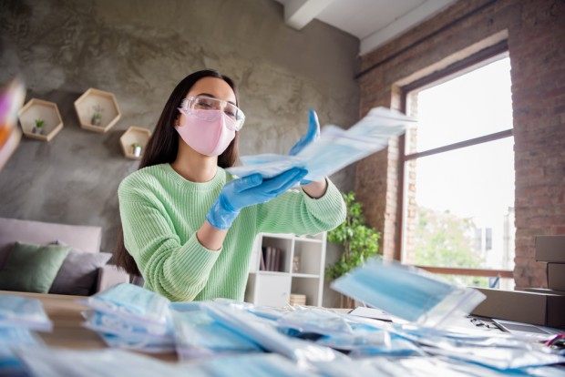 Photo of asian business lady hands throwing away giving free facial flu medical masks generous person delivery anti viral safety respirators into zipper bag stay home office indoors - stock image